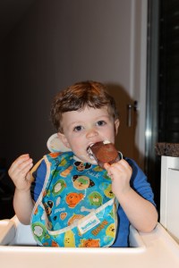 Henry eating his chocolate ice cream bar