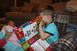 Reading Anna her first book, upside down of course