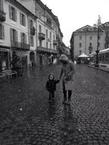 Abbie and Henry walking through the streets catching snowflakes